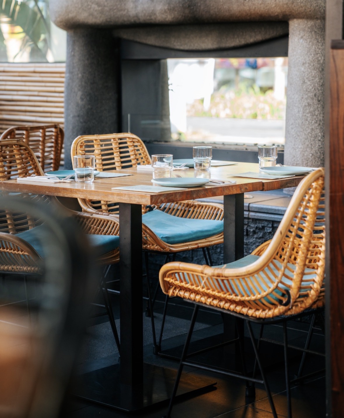 A set table with woven chairs at The Kokoscape