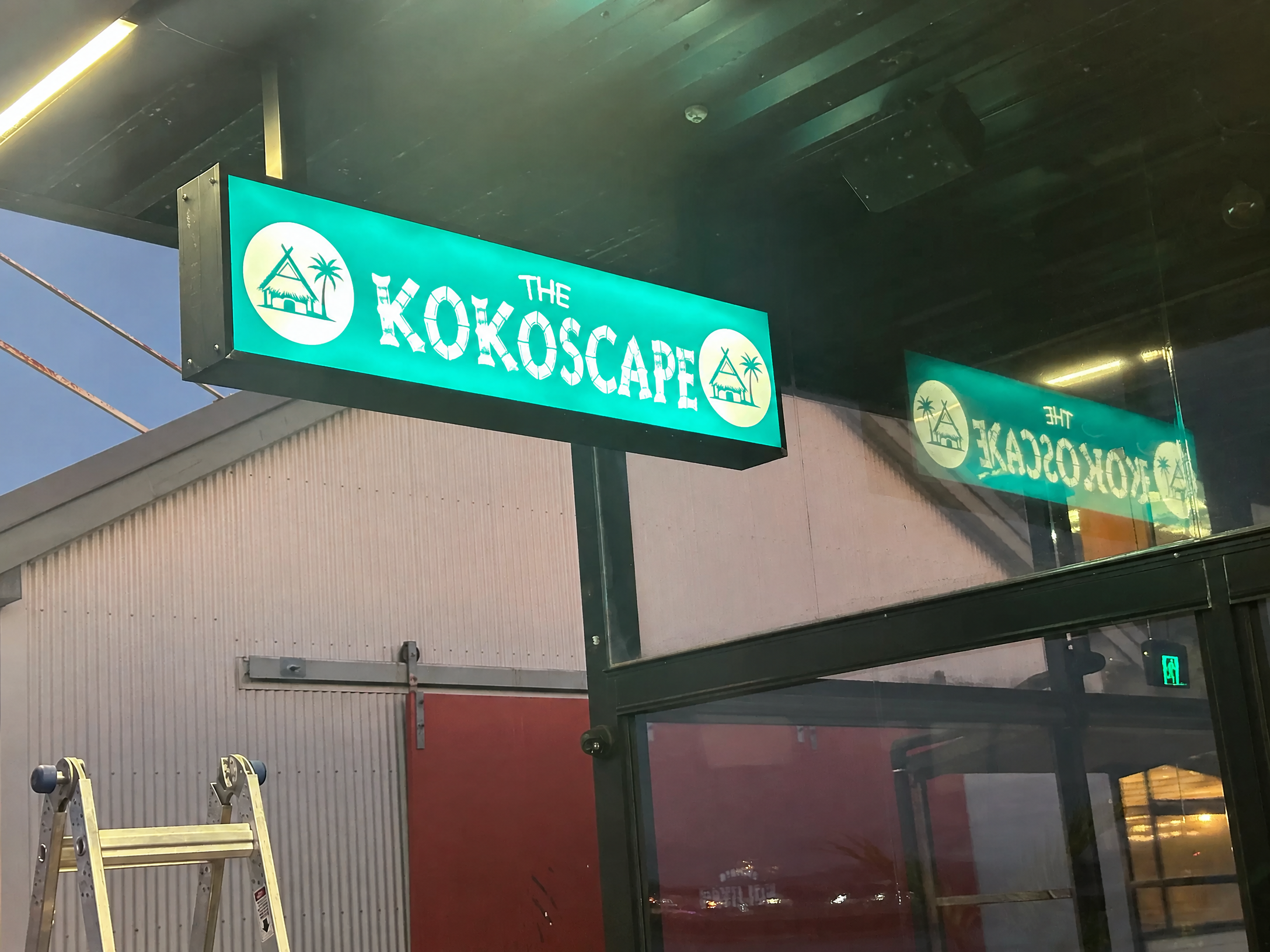 The Kokoscape teal-and-white exterior sign